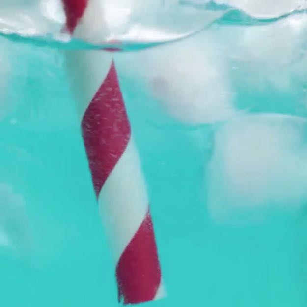 4th of July Drink | blue ocean drink with red striped straw closeup