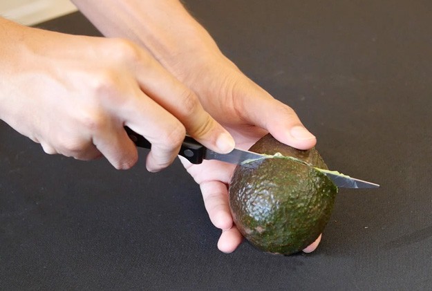 cut avocado across the middle | http://homemaderecipes.com/cooking-102/cooking-hacks/correct-way-to-cut-an-avocado/