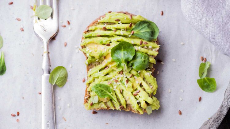 nM1FZ-SCXnE-wheat bread with avocado spread beside white plastic spoon-easy vegan recipes-us-feature