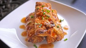 3HpyvyPCjPA-cooked food on dish-homemade egg rolls-us-feature