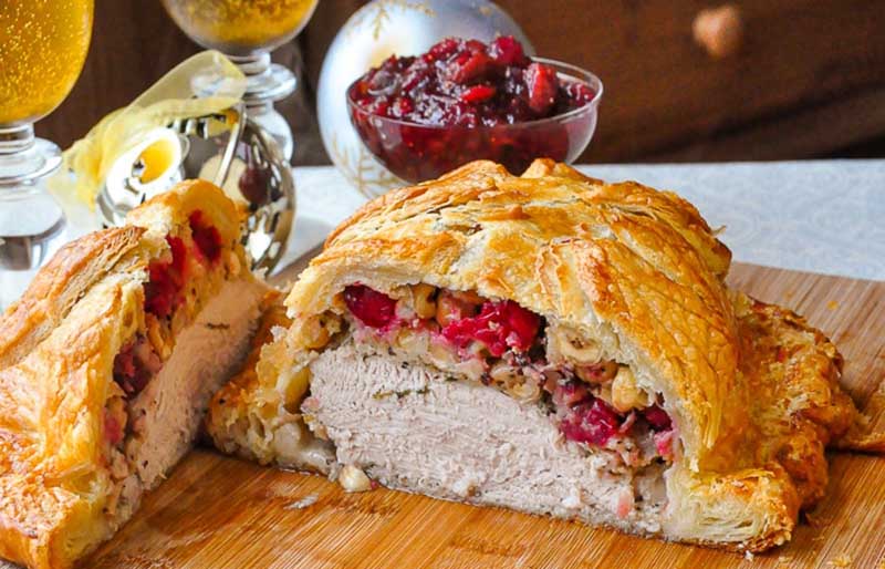 cranberry hazelnut turkey wellington cut open to reveal stuffing and turkey inside | leftover turkey recipes