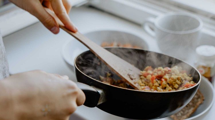 APDMfLHZiRA-person holding black frying pan-healthy cooking tips-us-feature