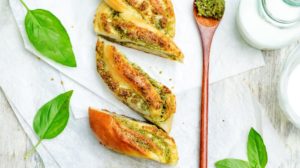 braided basil pesto bread on white | Homemade Bread Recipes With A Savory And Tasty Twist | featured