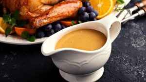 Homemade gravy in a sauce dish with turkey for Thanksgiving or Christmas | Easy Turkey Gravy Recipe | featured
