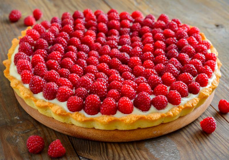 raspberry tart on wooden table | fancy dessert names