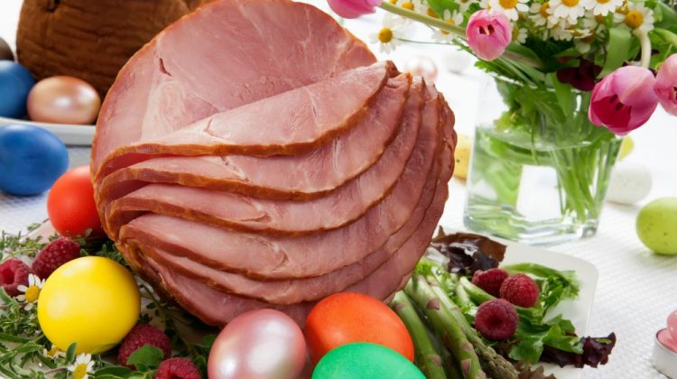 Whole baked honey sliced ham with fresh raspberry, asparagus, dyed Ester eggs, Easter cake, and cross buns | Must-Try Easter Ham Recipes For A Delightful Easter Dinner | how to cook an easter ham | Featured