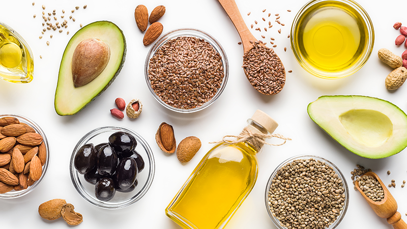 Avocado, almonds, hemp seeds, linseeds, olives and oils over white background | Stock-Up Grocery List And Recipes To Cook For Coronavirus Quarantine | Staple food