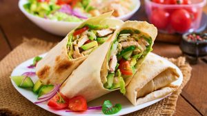 Fresh tortilla wraps with chicken and fresh vegetables on plate | Tasty Canned Chicken Recipes That Are Easy to Whip | recipes for canned chicken | Featured