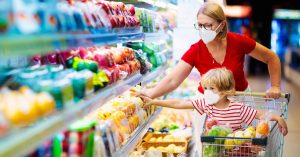 Mother and child buying fruit in supermarket | Stock-Up Grocery List And Recipes To Cook For Coronavirus Quarantine | Staple food | Featured