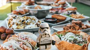 Storm trooper walking on table with plates of food | Easy And Out Of This World Star Wars Recipes For May The 4th Be With You | space themed snacks | featured