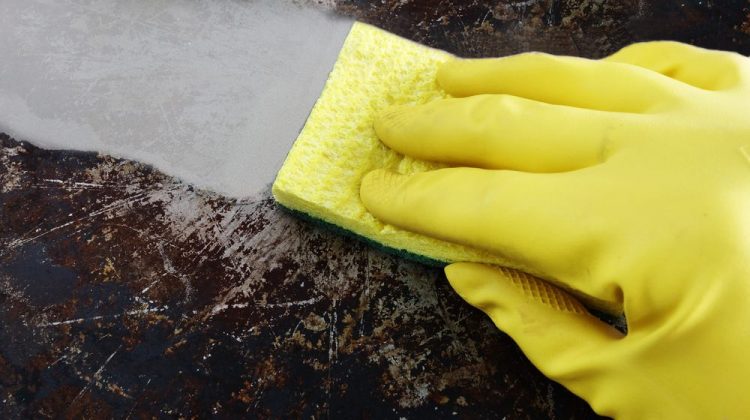 cleaning-greasy-pan-yellow-latex-gloves | How To Remove Baked-on Grease From Oven, Pans & Pots | Featured