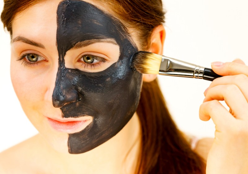 skin care female applying black purifying | charcoal mask before and after