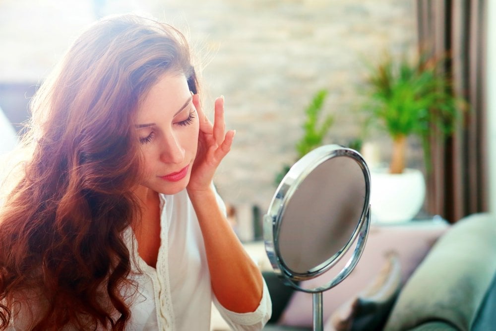 Face of young beautiful healthy woman looking in the mirror | Make This Easy Homemade Bone Broth Recipe (+ Benefits) | homemade bone broth