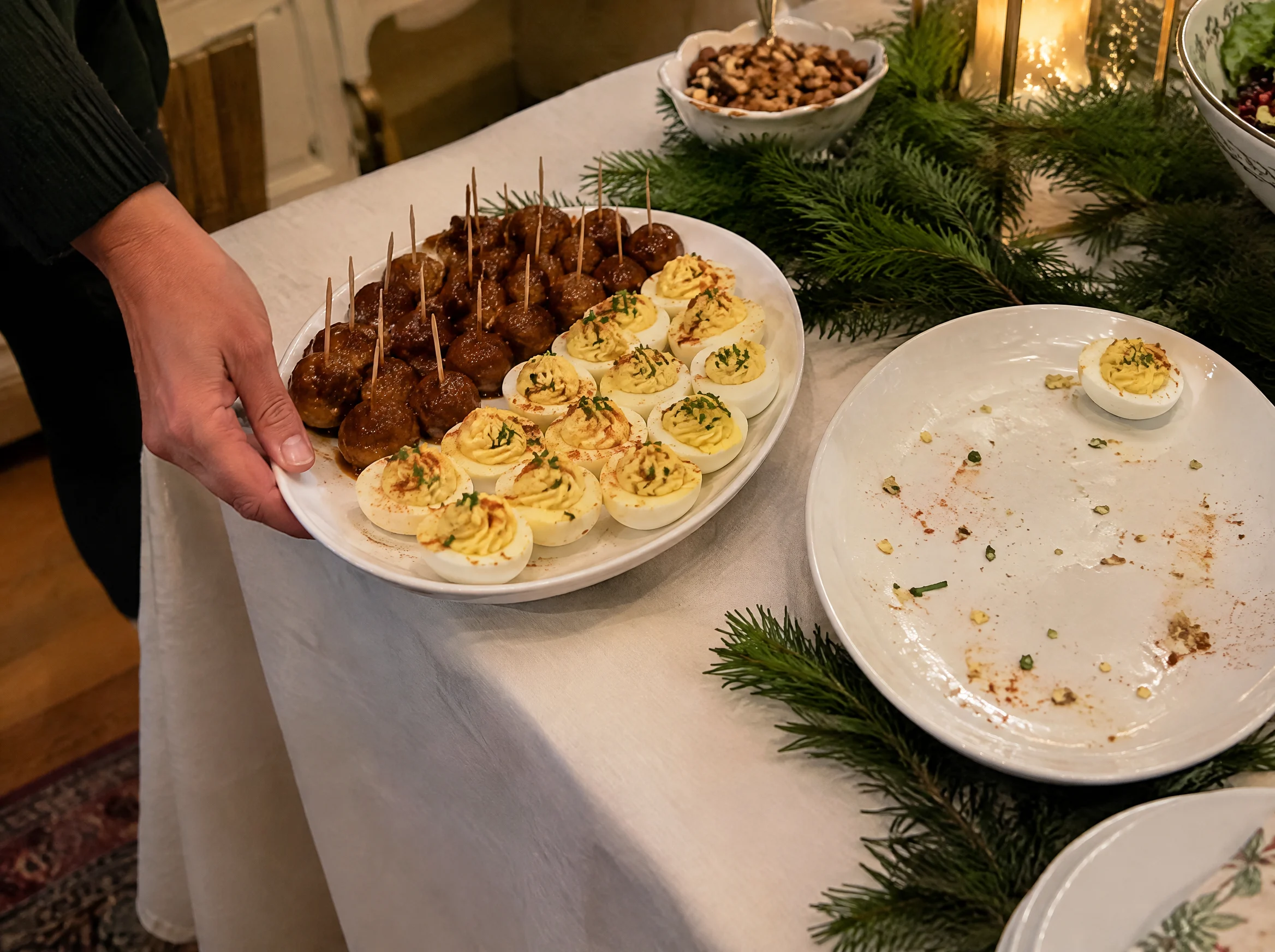 Swapping in a fresh platter of Christmas party appetizers next to an empty one