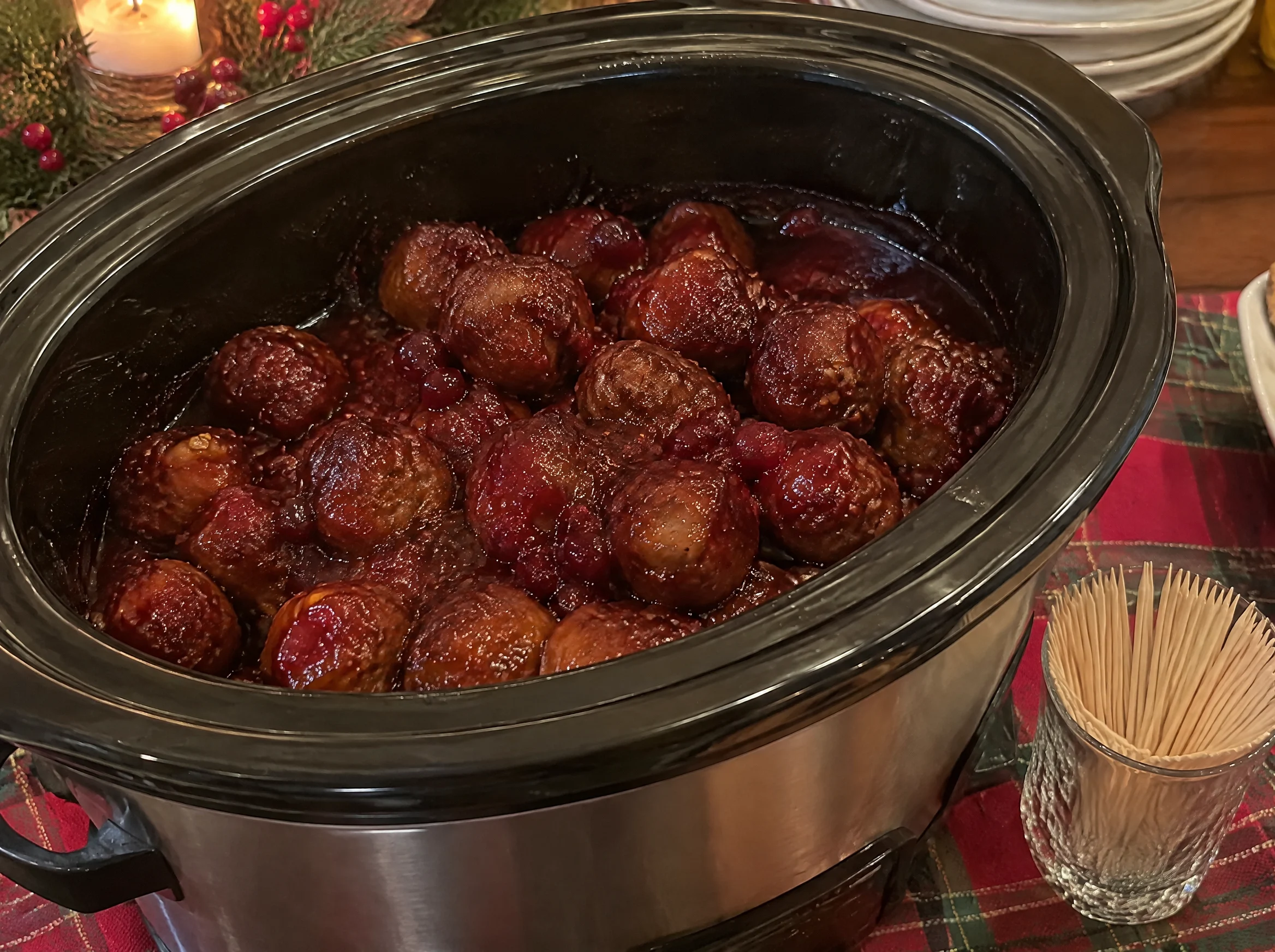 Slow cooker cranberry chili meatballs with toothpicks for a Christmas party